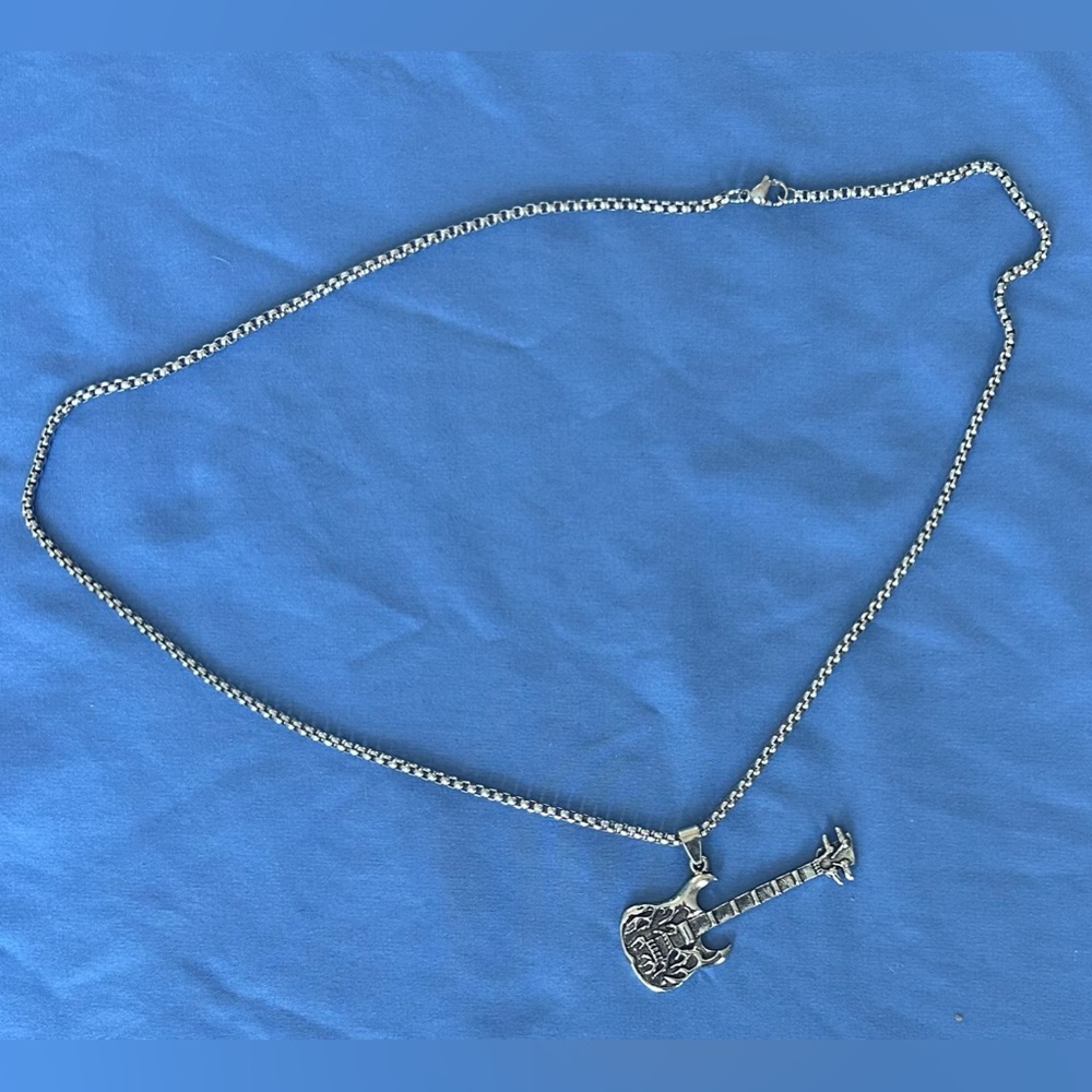 flame guitar and skull n horns mask pendants and chains